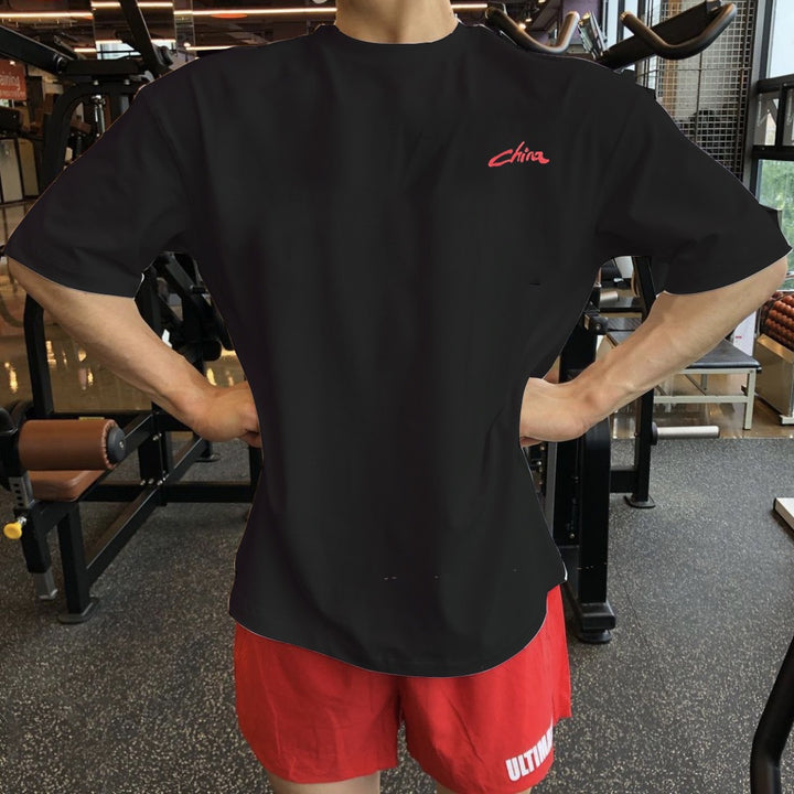 Ropa de entrenamiento muscular para hombre de manga corta de estilo chino, camiseta deportiva holgada versátil e informal con hombros caídos y media manga.