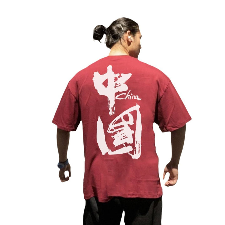 Ropa de entrenamiento muscular para hombre de manga corta de estilo chino, camiseta deportiva holgada versátil e informal con hombros caídos y media manga.